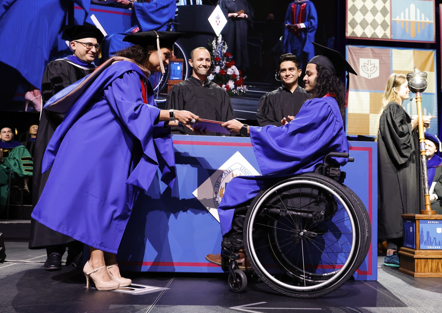 Graduate Linda Annicks, presented her son, Jonathan Annicks, his degree at the DePaul University commencement ceremony for the Kellstadt Graduate School of Business.